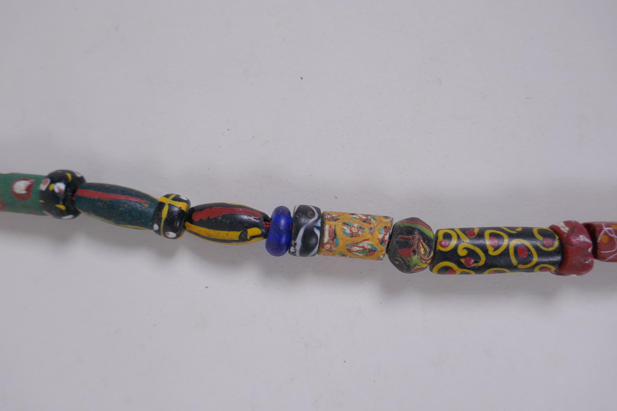 An Islamic multicolour glass bead necklace with a mille fiori feature bead, 88cm long - Image 4 of 6