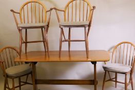 An Ercol 1960s elm Old Colonial refectory table, four Ercol elm and beech hoop back Windsor