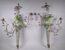 A pair of two branch porcelain and gilt metal parrot wall sconces decorated in bright enamels, 52