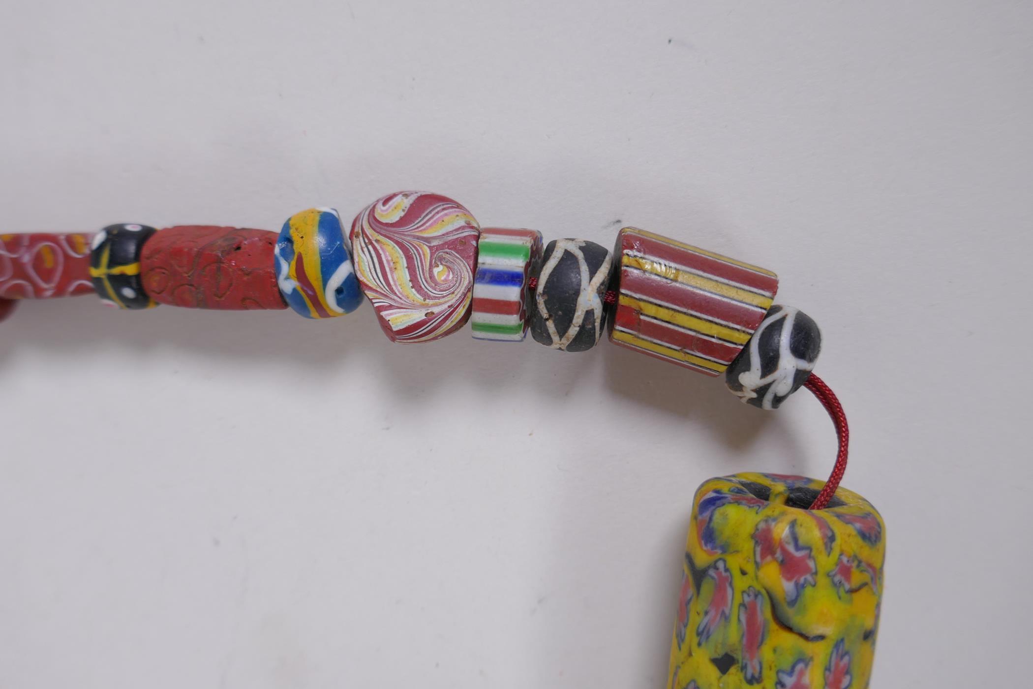 An Islamic multicolour glass bead necklace with a mille fiori feature bead, 88cm long - Image 3 of 6
