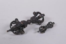 A Tibetan bronze vajra and another smaller, 11cm long