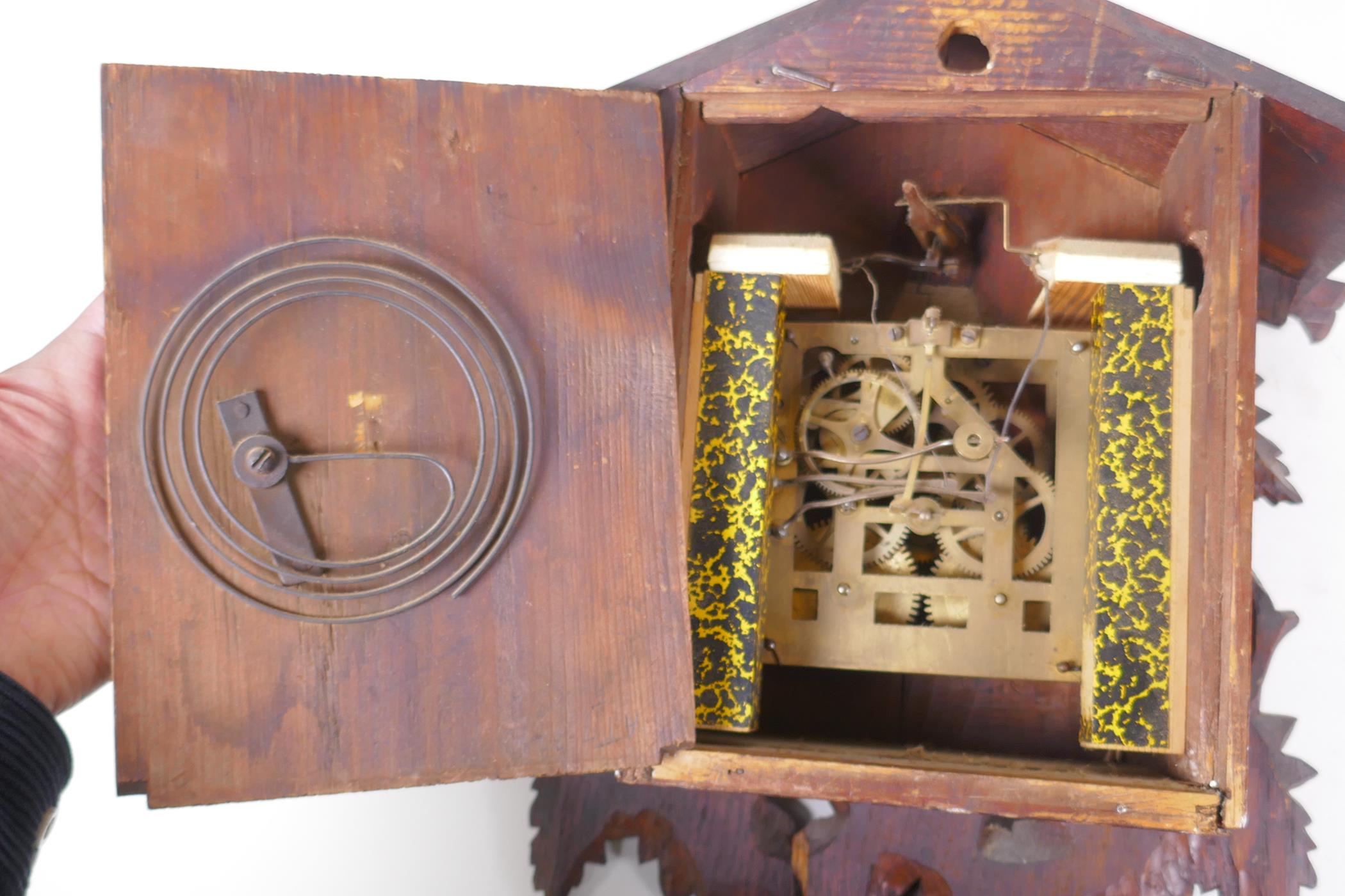 An antique carved Black Forest cuckoo clock, bellows intact, AF, 33 x 42cm - Image 7 of 7