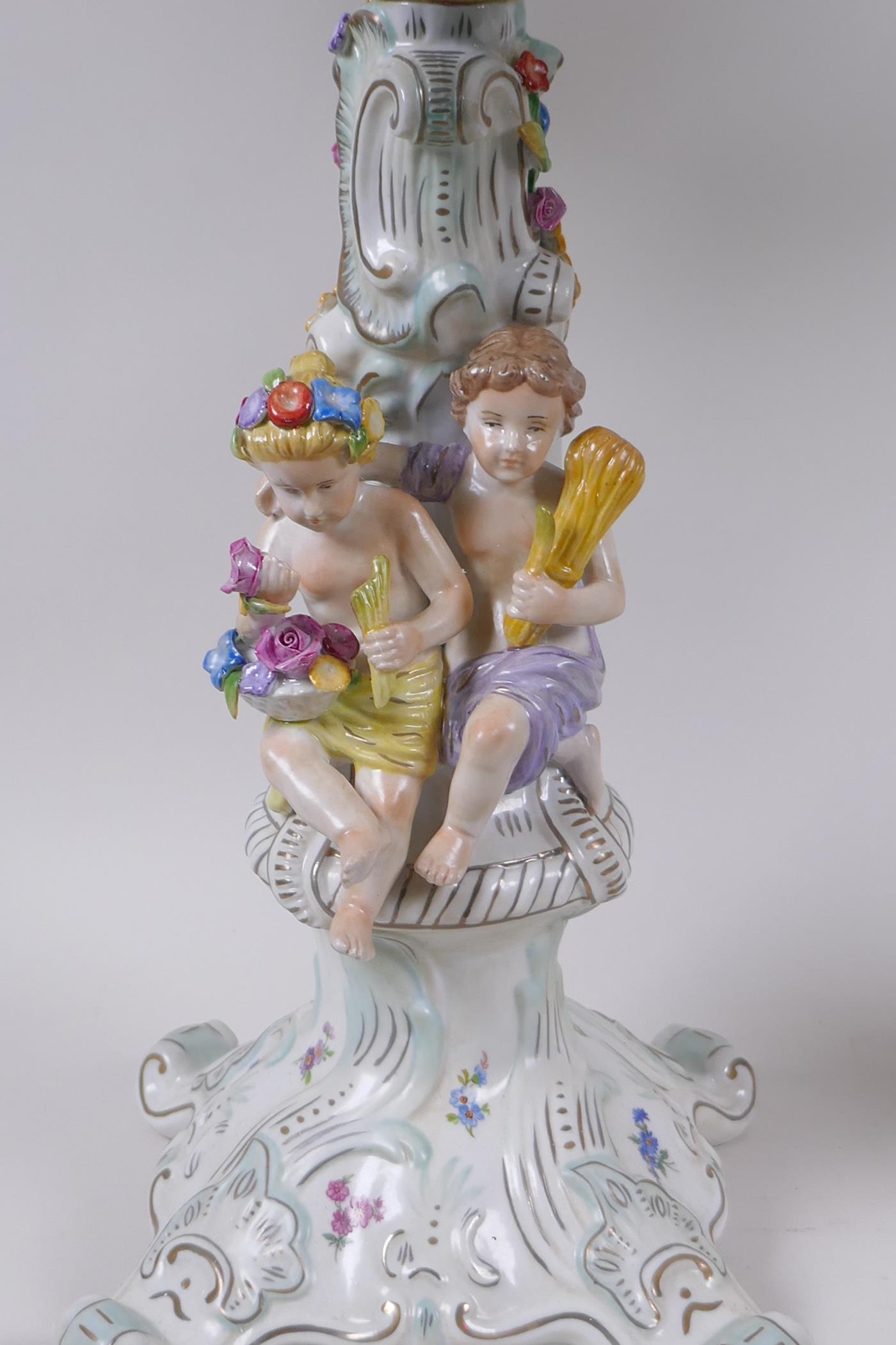 A pair of continental porcelain four branch candelabra decorated with putti, 59cm high - Image 3 of 8