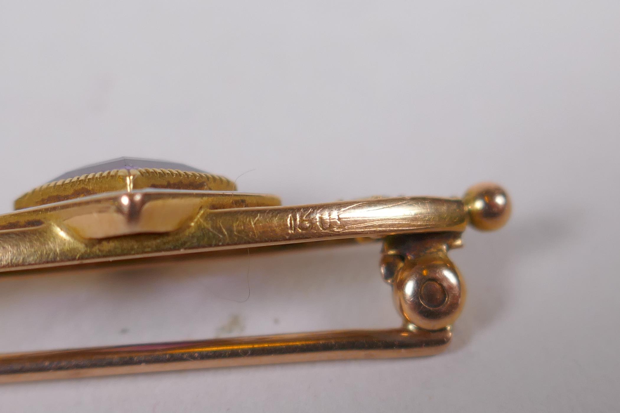 A 15ct gold suffragette brooch set with an amethyst and peridot, and enamel decoration, 3cm long, 3g - Image 3 of 4