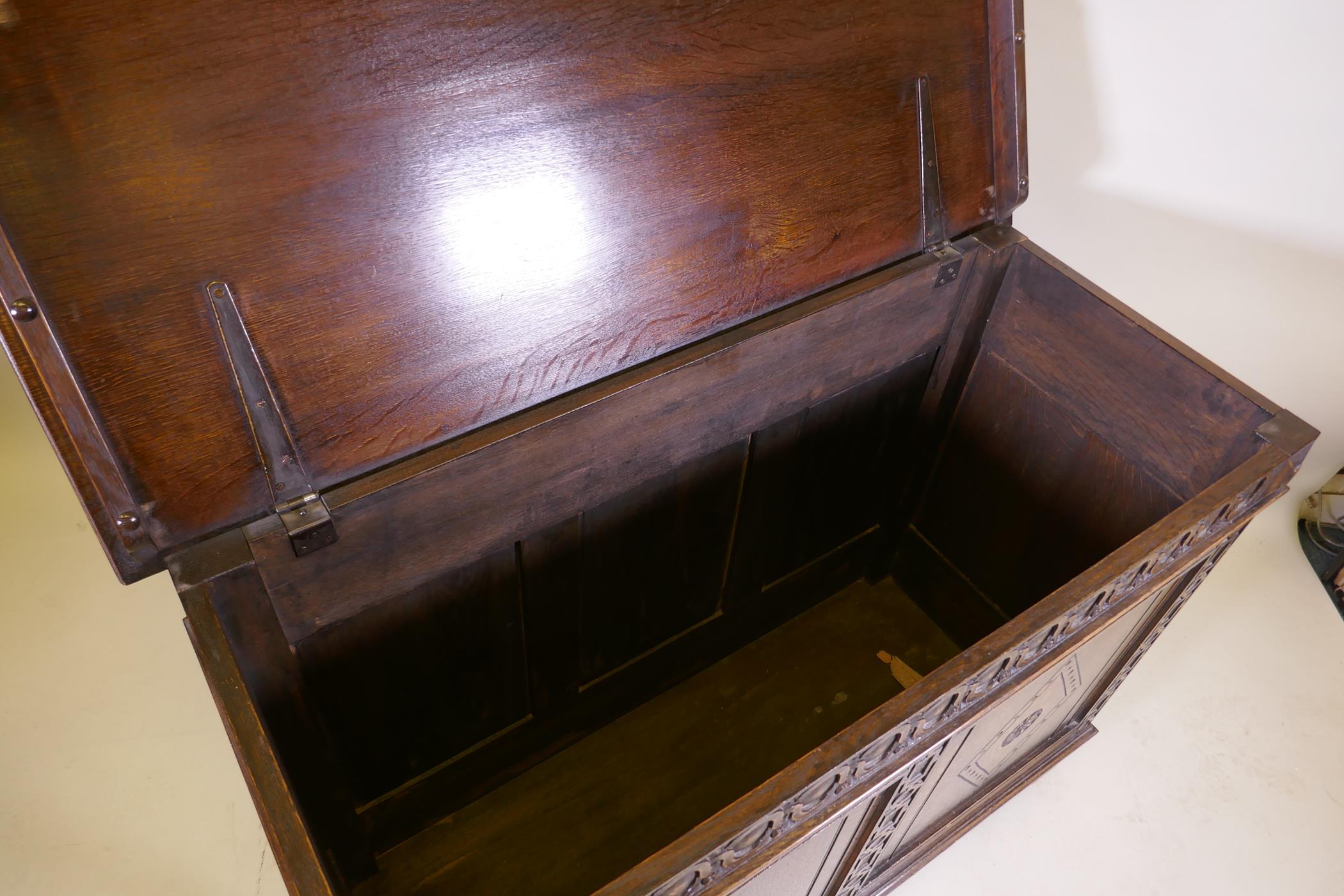 An oak blanket chest, with lift up top, carved frieze and panelled front and sides, raised on - Image 4 of 4