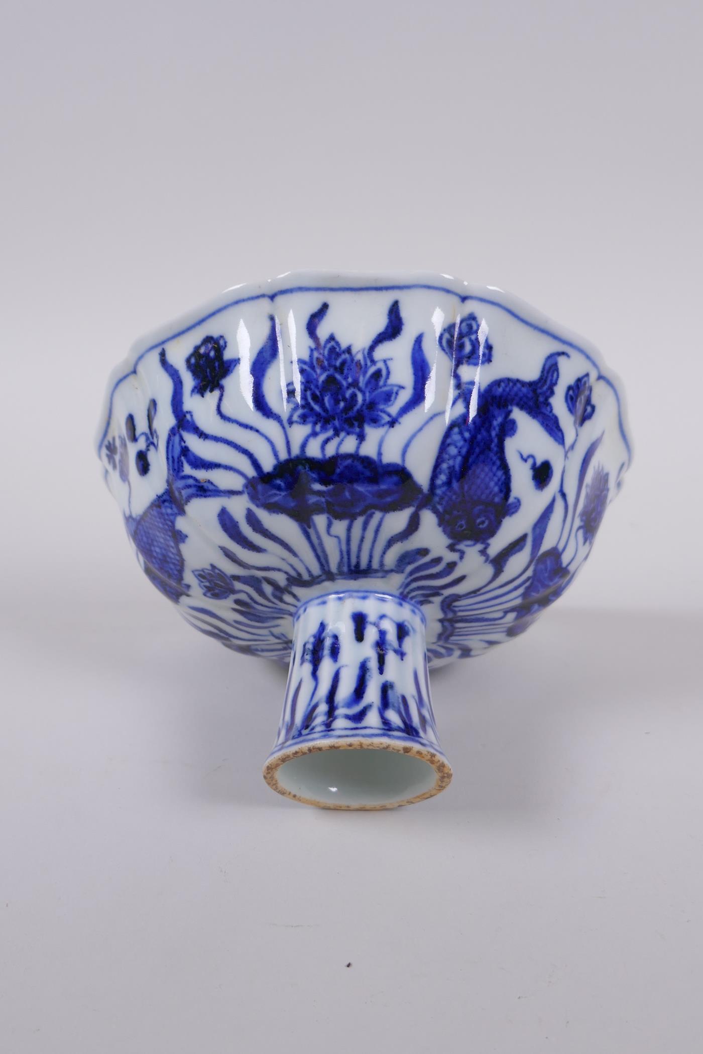 A blue and white porcelain stem bowl of lobed form, decorated with carp in a lotus pond, Chinese - Image 3 of 7