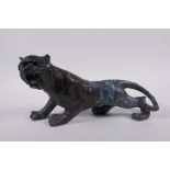 An oriental filled bronzed figure of a tiger, 30cm long