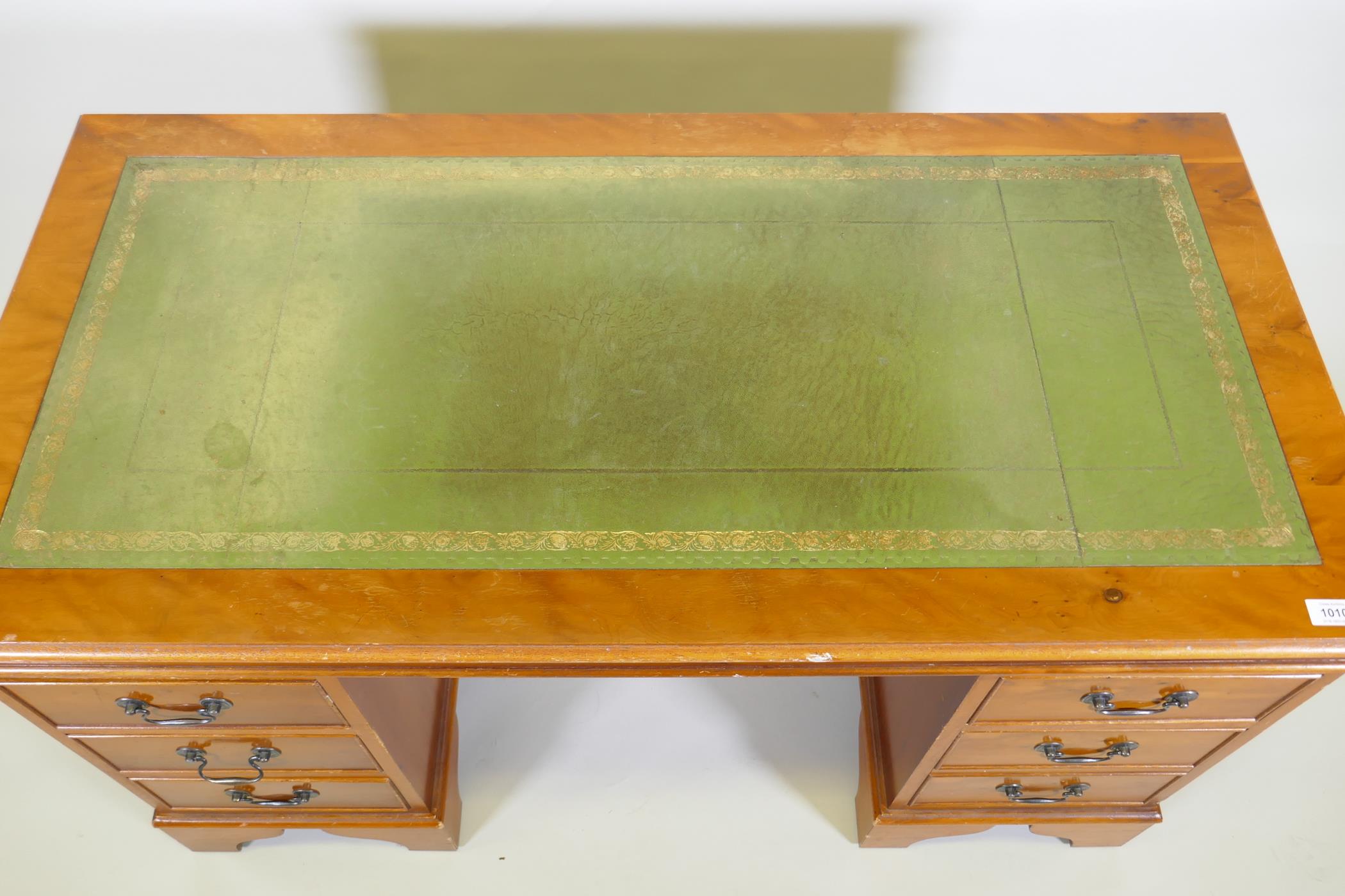 A yew wood five drawer pedestal desk with leather inset top, raised on bracket supports, 122 x 61 - Image 4 of 4