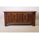 An old charm oak coffer with triple panel front and carved decoration, 113 x 52 x 45cm