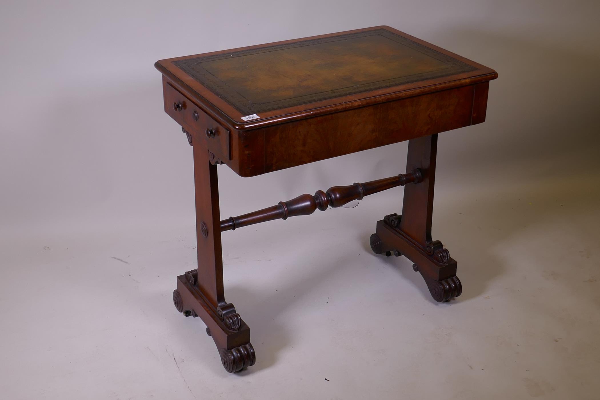 A Georgian mahogany writing table with two end drawers and tooled leather inset top, raised on