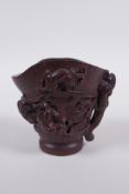 A Chinese carved bamboo libation cup with climbing kylin decoration, impressed seal mark to base,