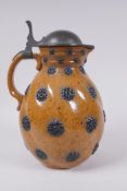 A German Reinheart Merkelbach stoneware art pottery pitcher of swirled form with applied floral