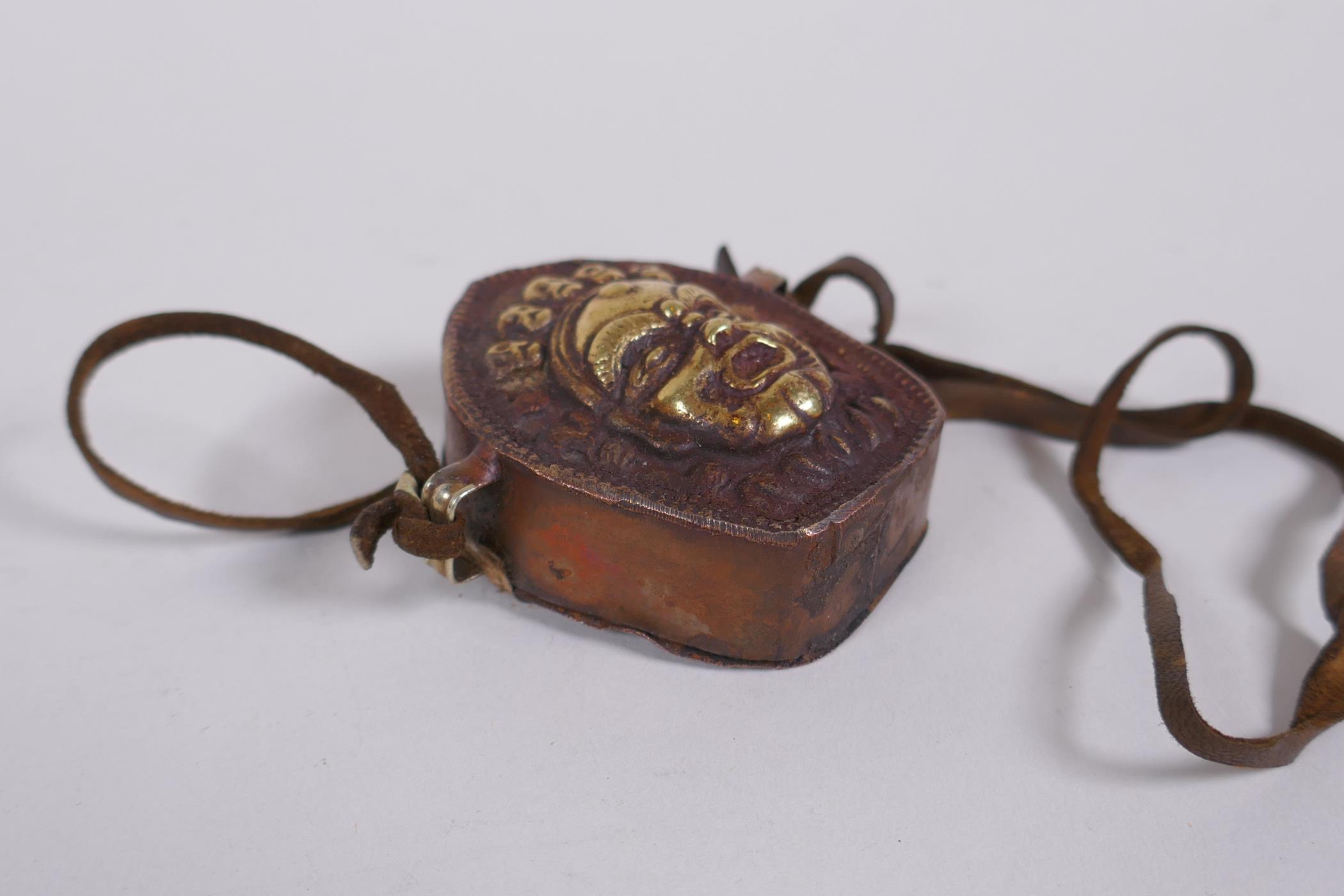 A Tibetan copper gau prayer box, with gilt repousse decoration of a wrathful deity, 6 x 6cm - Image 3 of 4