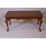 A Queen Anne style coffee table with figured walnut top and inset glass, labelled H. Shaw, London,