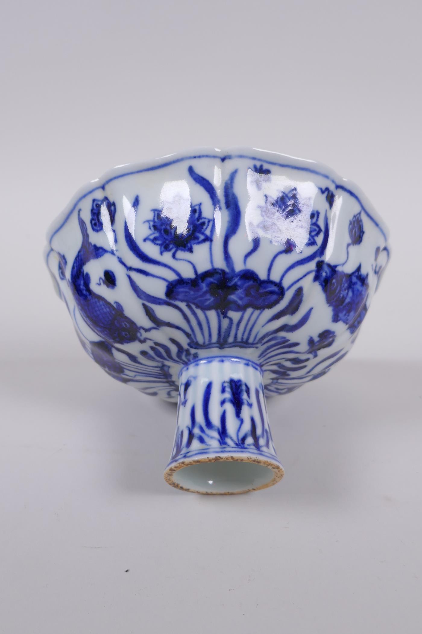 A blue and white porcelain stem bowl of lobed form, decorated with carp in a lotus pond, Chinese - Image 4 of 7