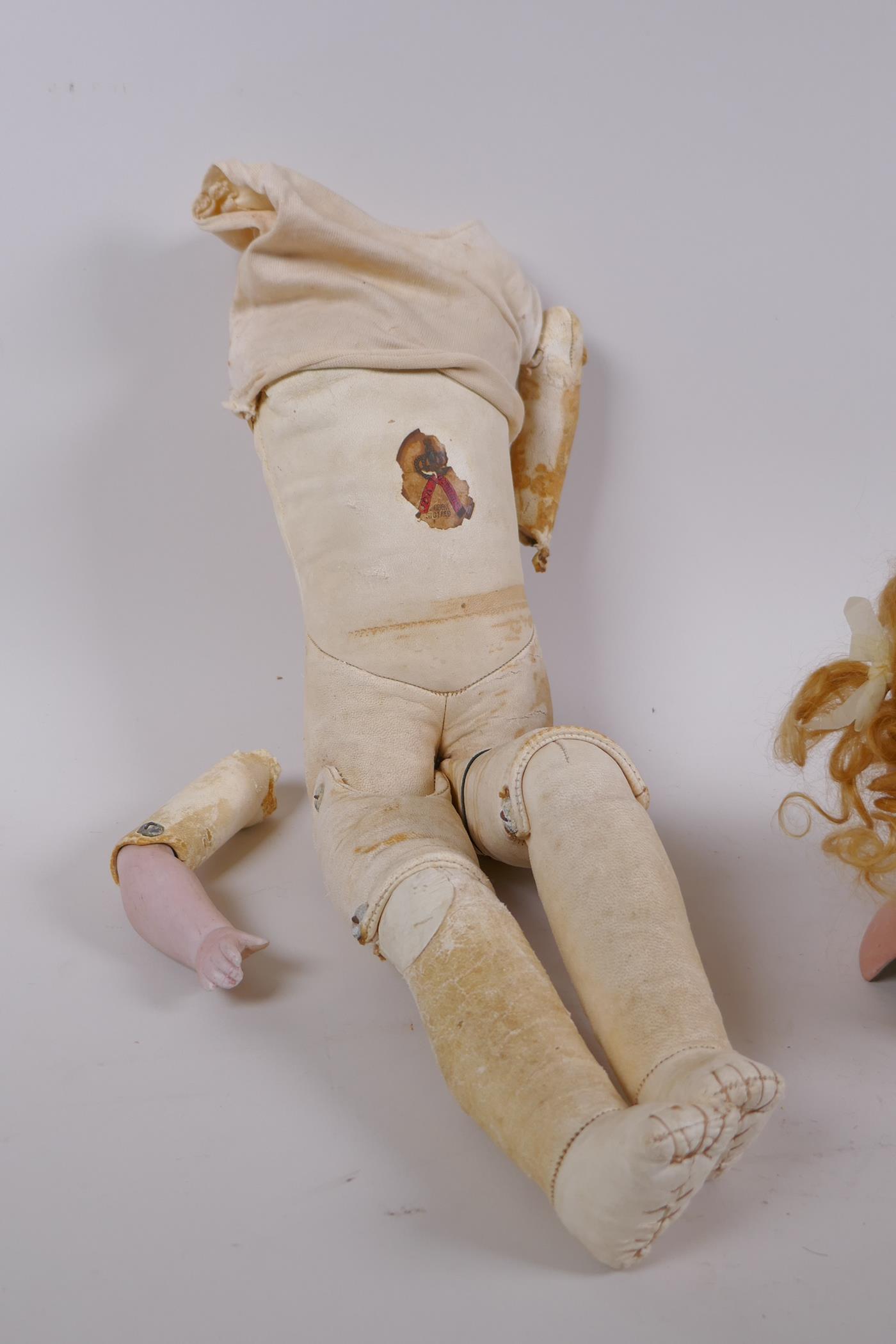 An antique German Bisque dolls head with open and shut eyes, and an associated torso, the head - Image 4 of 4
