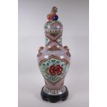 A Chinese porcelain jar and cover with two kylin mask handles, Fo dog knop and red and green