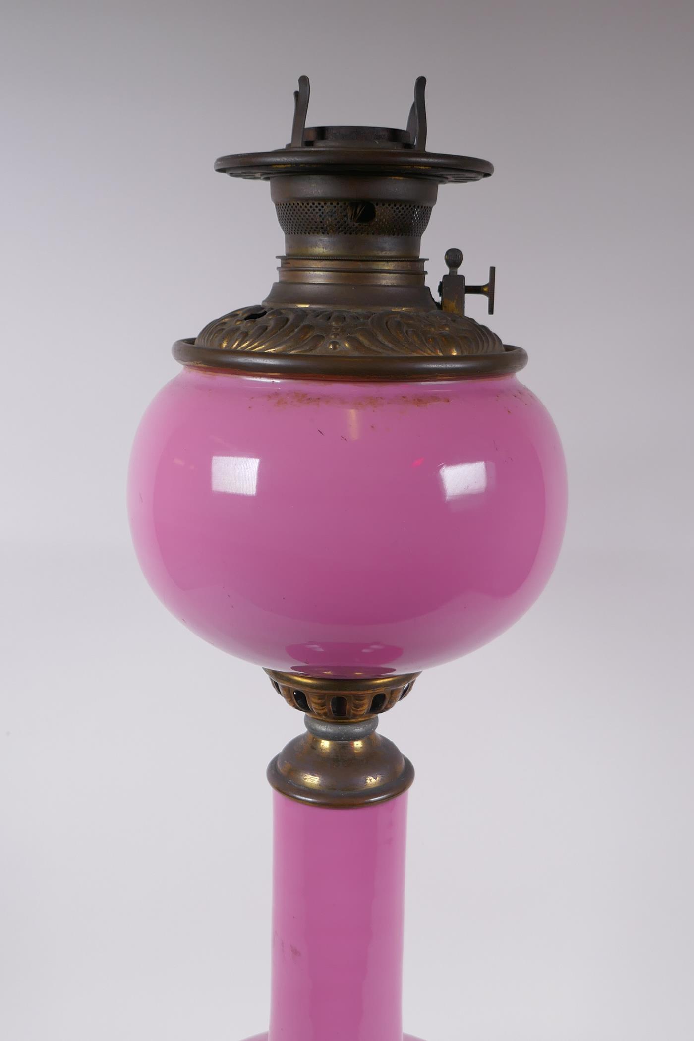 A pink glass and brassed metal oil lamp converted to electricity, 64cm high - Image 2 of 5