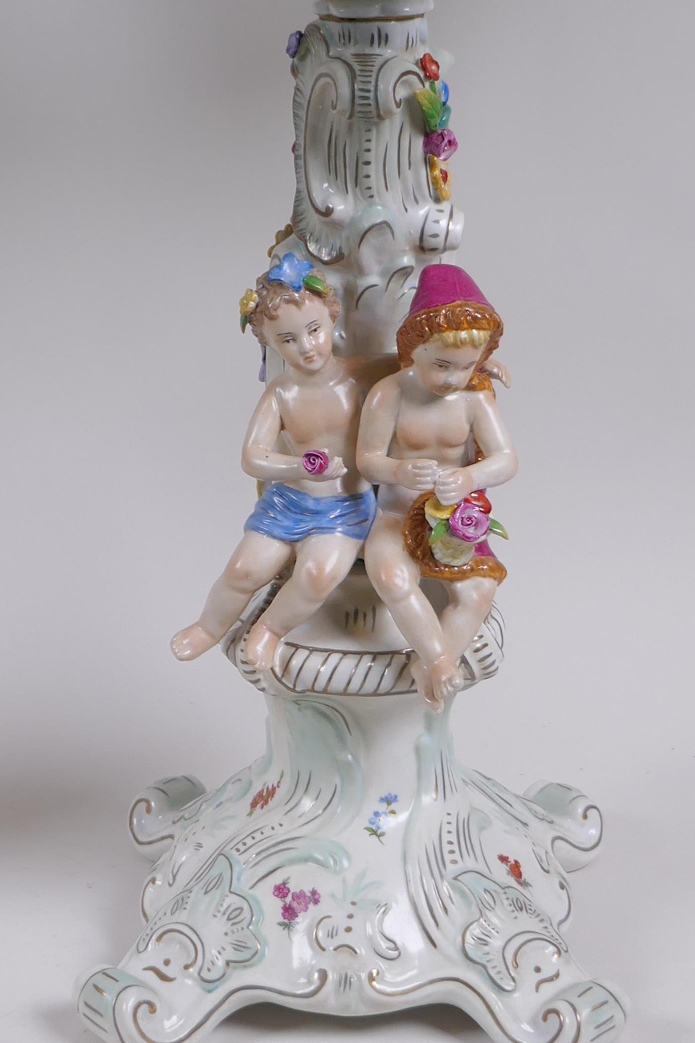 A pair of continental porcelain four branch candelabra decorated with putti, 59cm high - Image 5 of 8