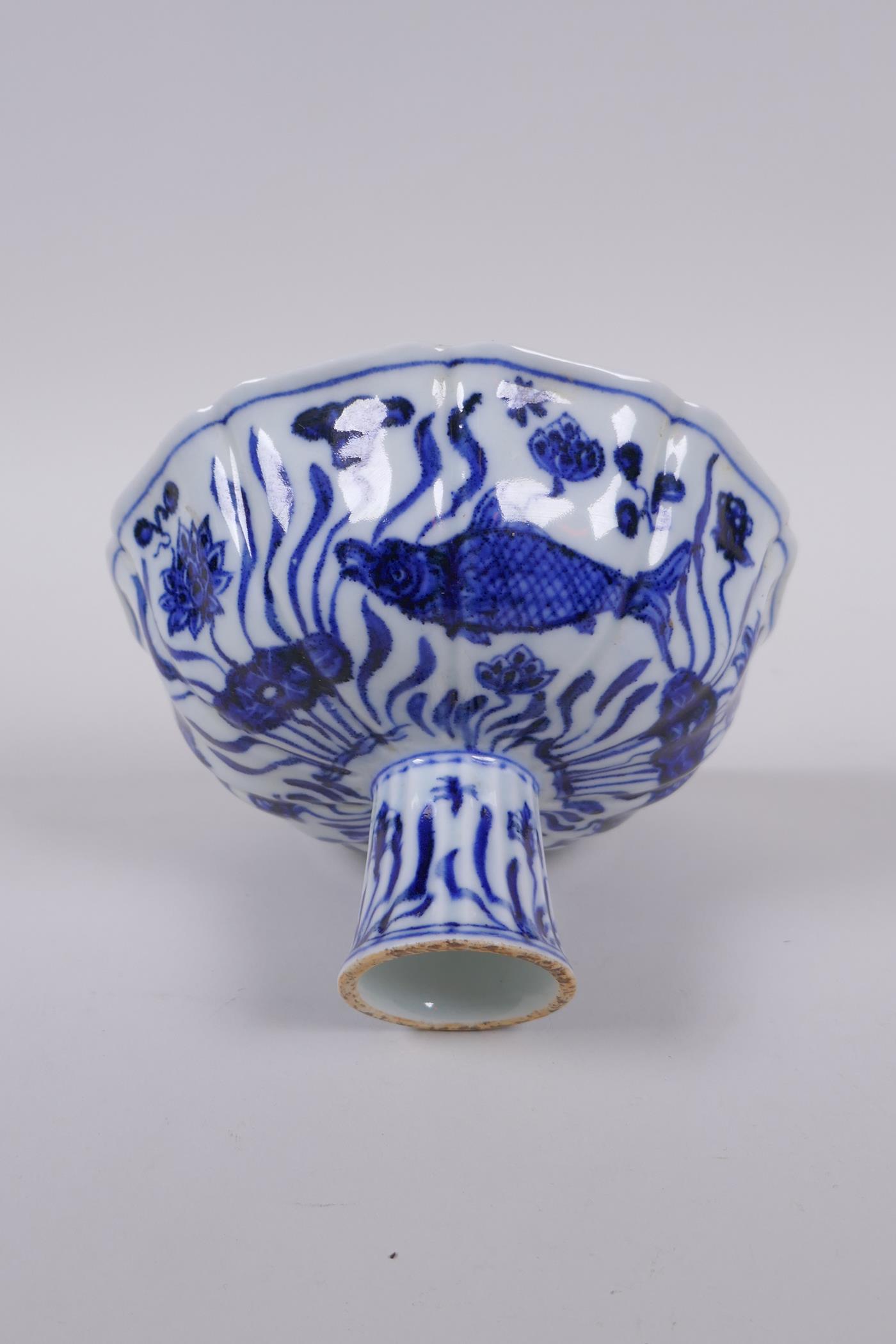 A blue and white porcelain stem bowl of lobed form, decorated with carp in a lotus pond, Chinese - Image 2 of 7