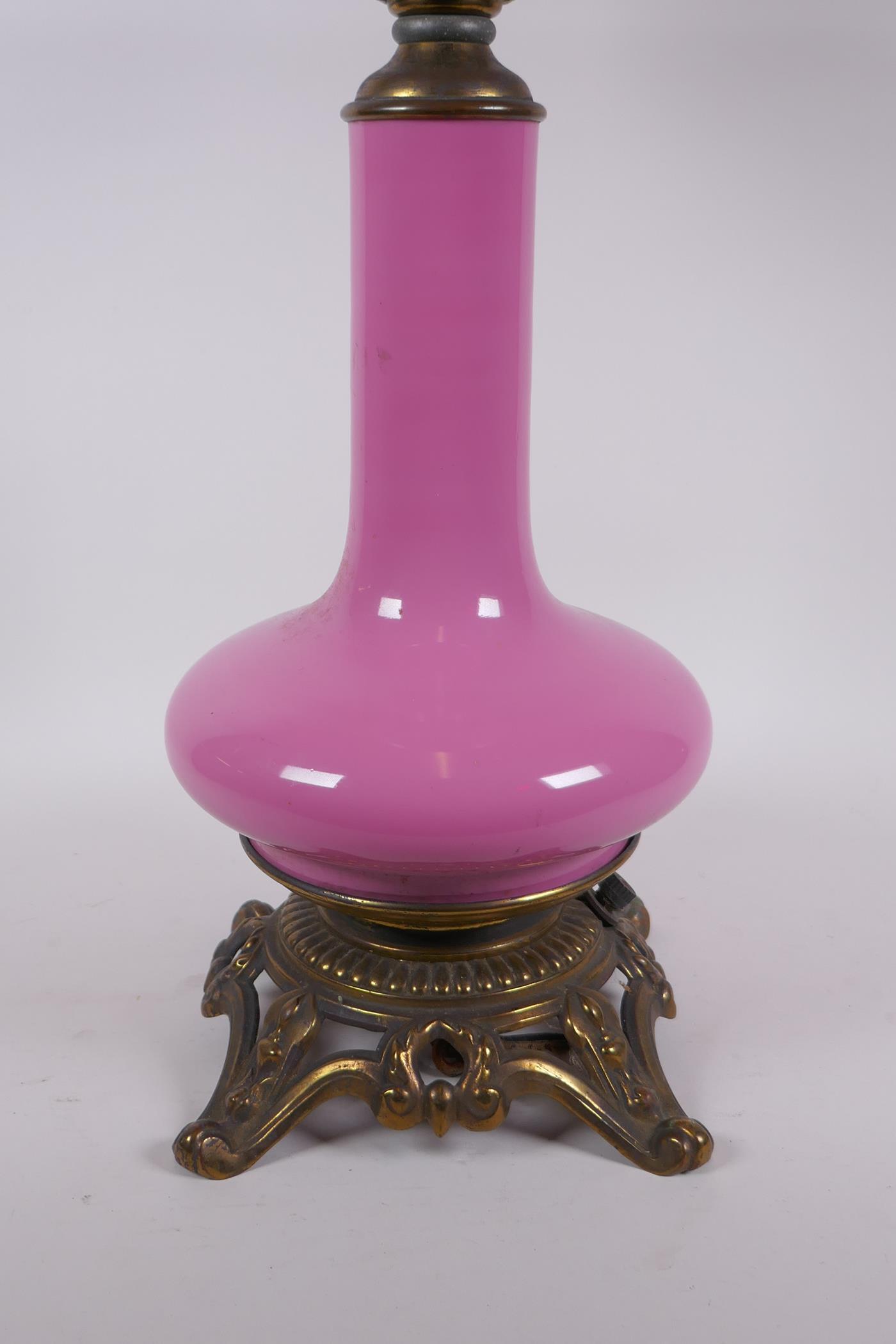 A pink glass and brassed metal oil lamp converted to electricity, 64cm high - Image 3 of 5
