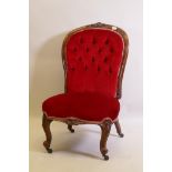 A Victorian walnut spoon back nursing chair