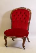 A Victorian walnut spoon back nursing chair