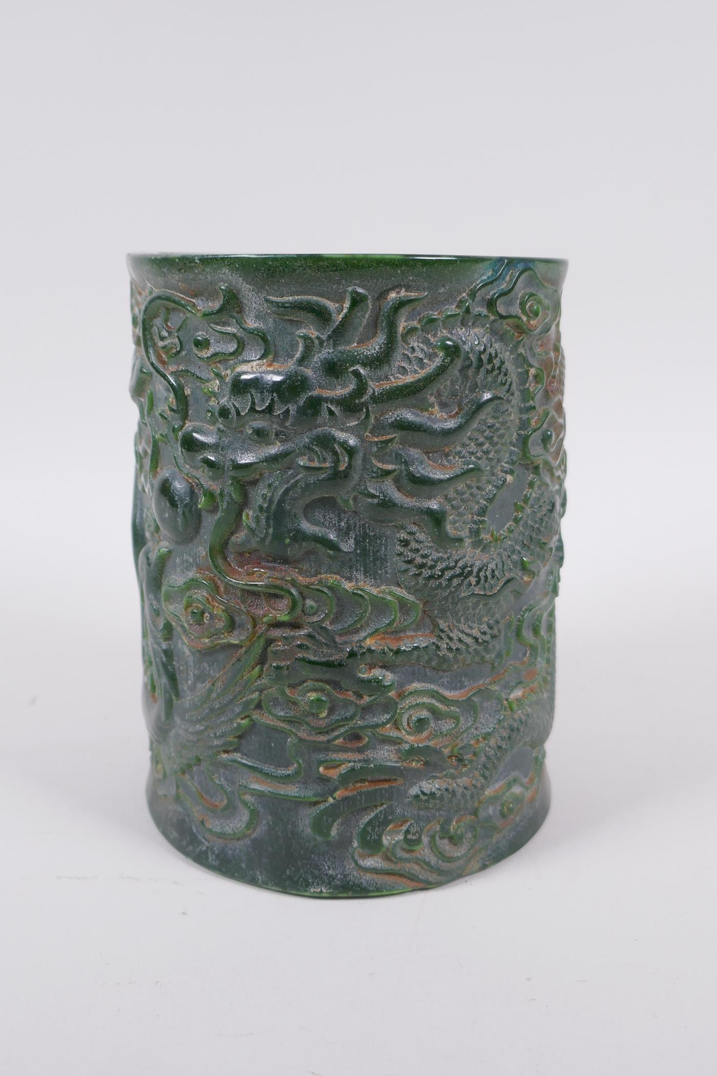 A Chinese carved green hardstone brush pot decorated with a dragon and phoenix, Qianlong seal mark