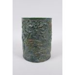 A Chinese carved green hardstone brush pot decorated with a dragon and phoenix, Qianlong seal mark