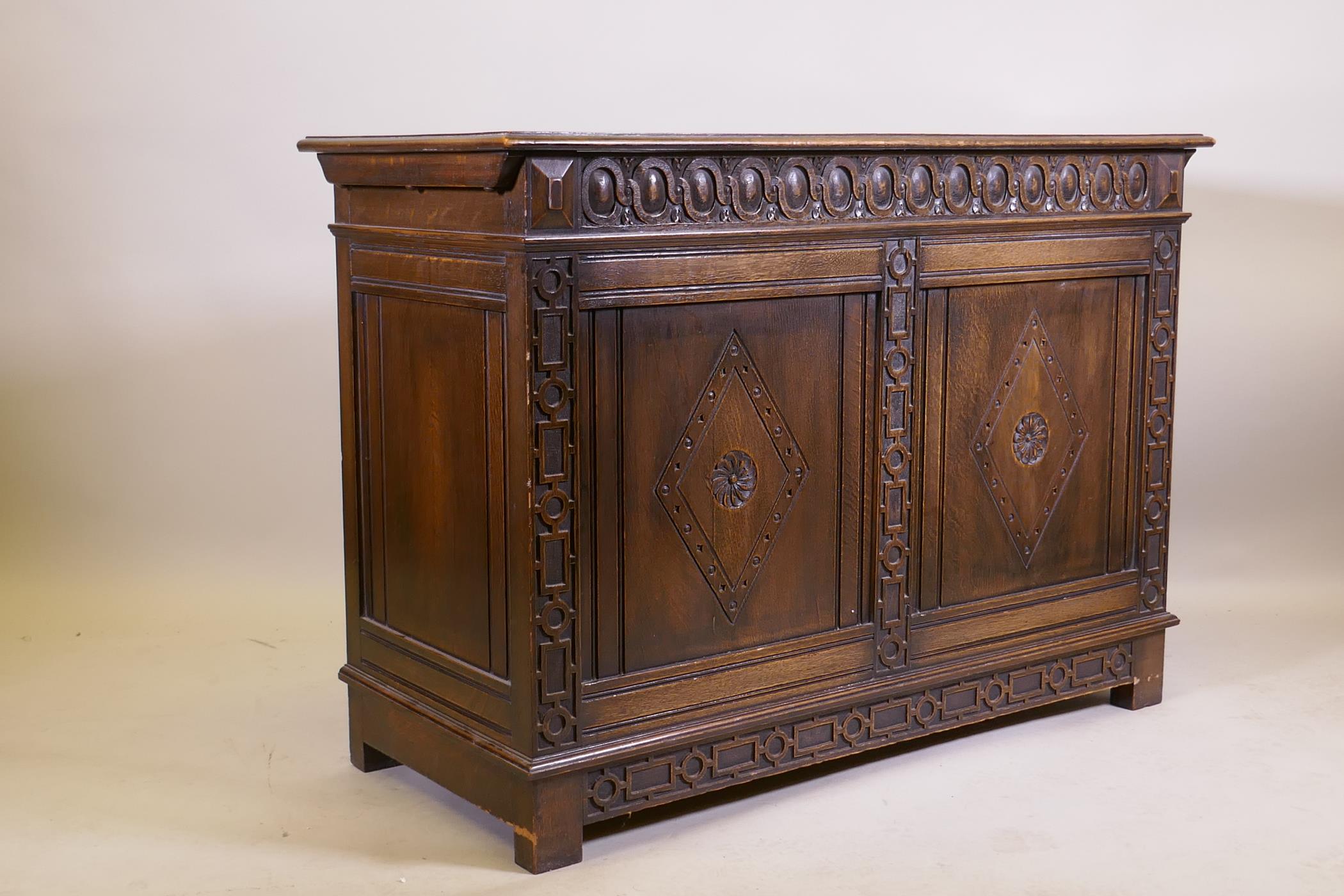 An oak blanket chest, with lift up top, carved frieze and panelled front and sides, raised on - Image 3 of 4