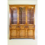 A Georgian style mahogany bookcase/display cabinet, the upper section with dentil cornice,