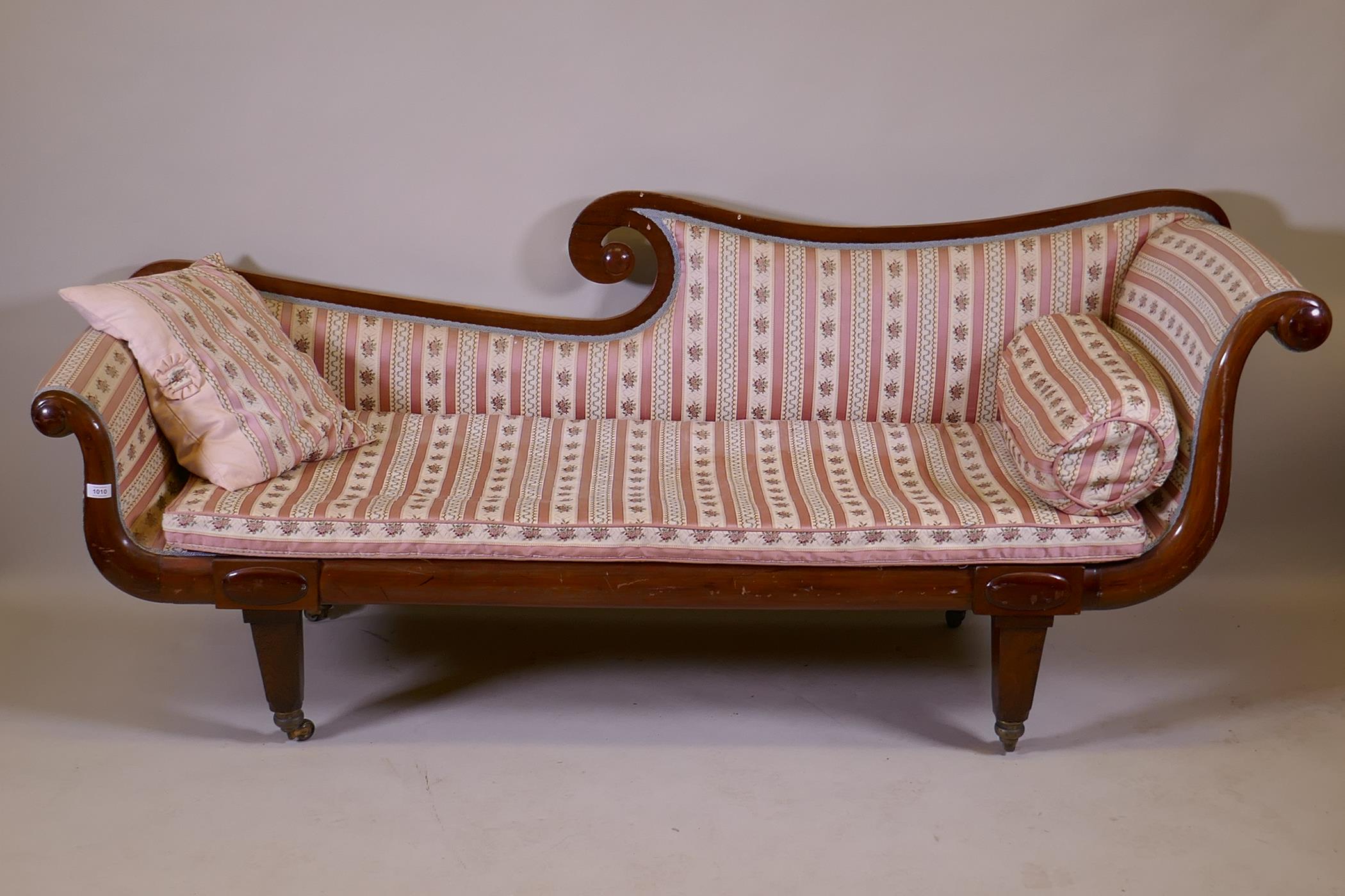 A C19th walnut chaise longue with scrolled ends, raised on tapering supports with brass castors, 200