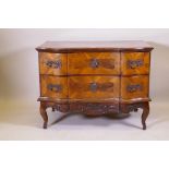 A late C18th/early C19th Maltese serpentine fronted walnut commode with two drawers, raised on a