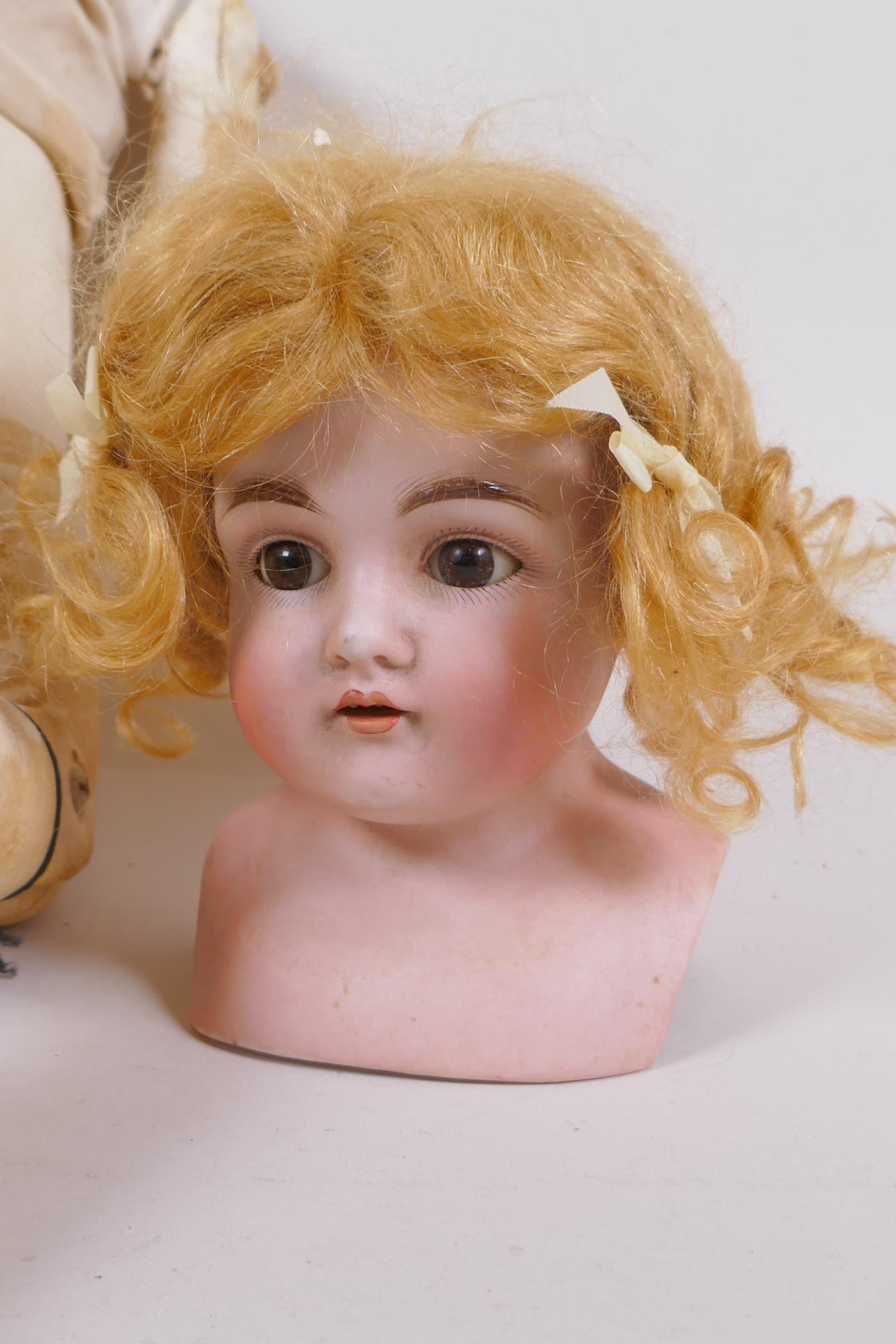 An antique German Bisque dolls head with open and shut eyes, and an associated torso, the head - Image 2 of 4