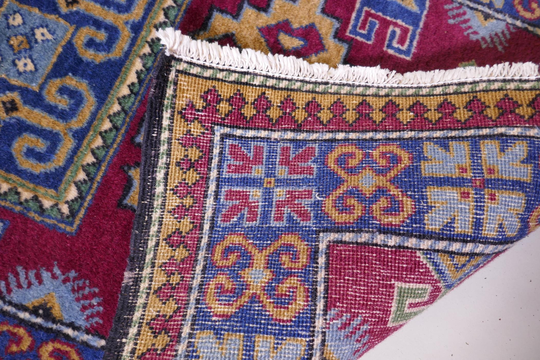 A claret wine ground wool caucasian runner with bespoke medallion design in unique colours, 322 x - Image 6 of 6