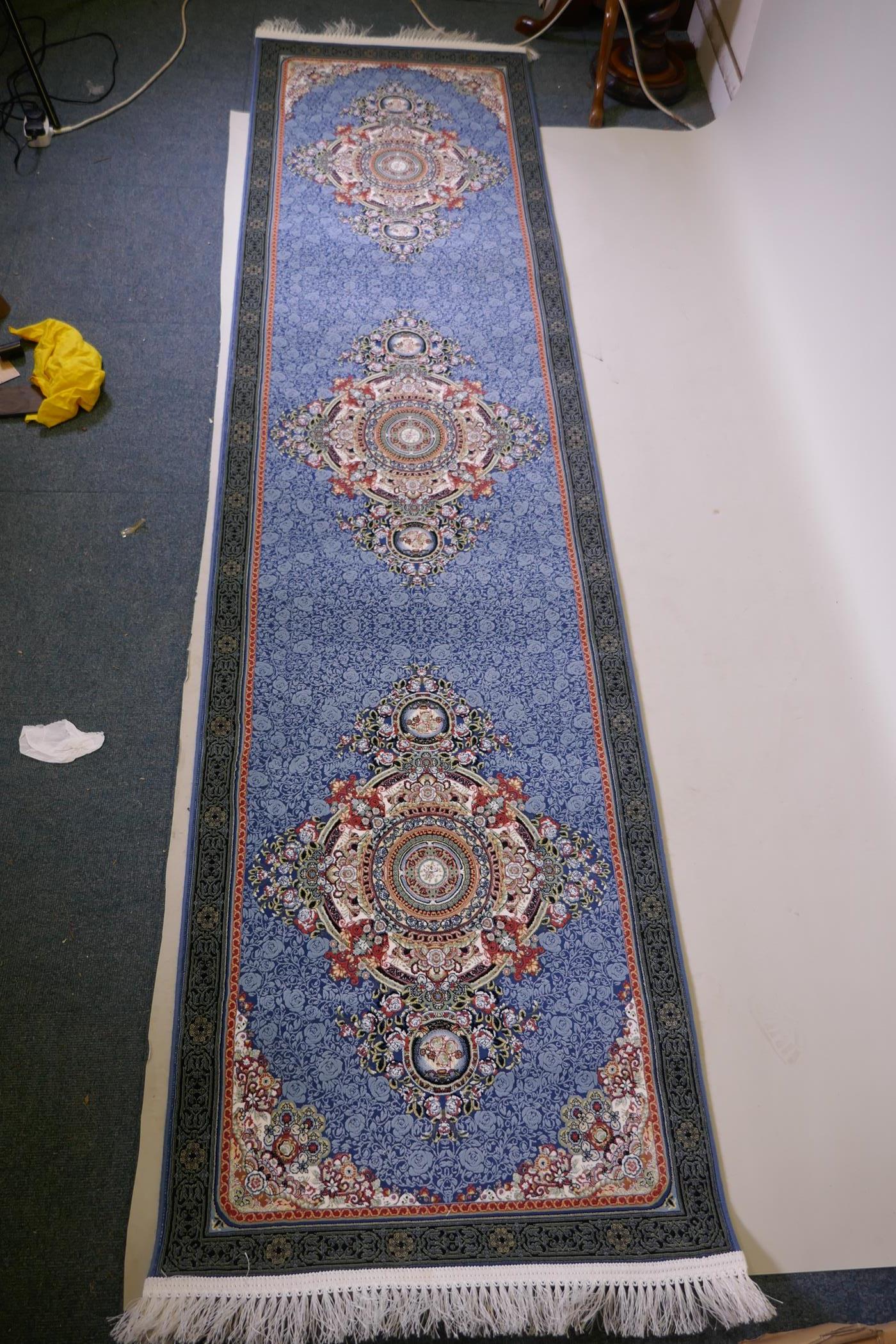 An Iranian fine woven blue ground runner with a medallion design surrounded by an embossed all - Image 3 of 5