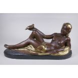 A bronzed and gilt plaster figure of a reclining female nude, 75cm long, 35cm high