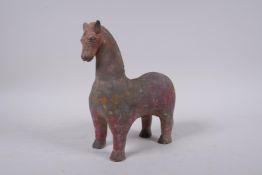 A middle eastern painted terracotta horse, 21cm high