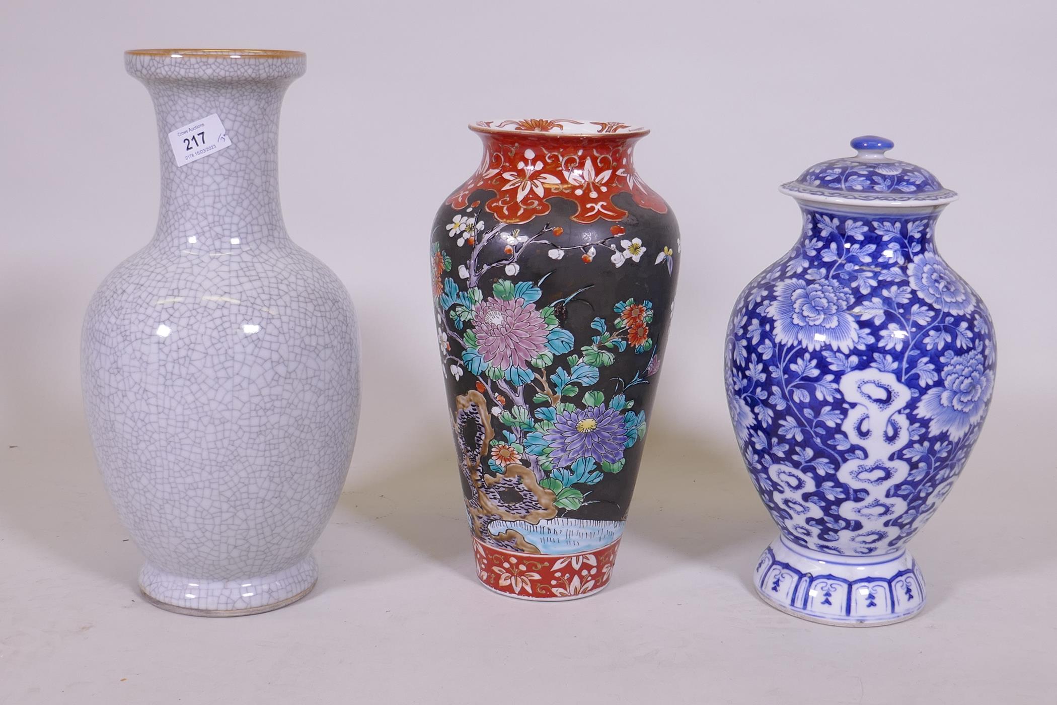 An oriental blue and white jar and cover, 30cm high, a famille noir vase with floral decoration