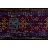 A claret wine ground wool caucasian runner with bespoke medallion design in unique colours, 322 x