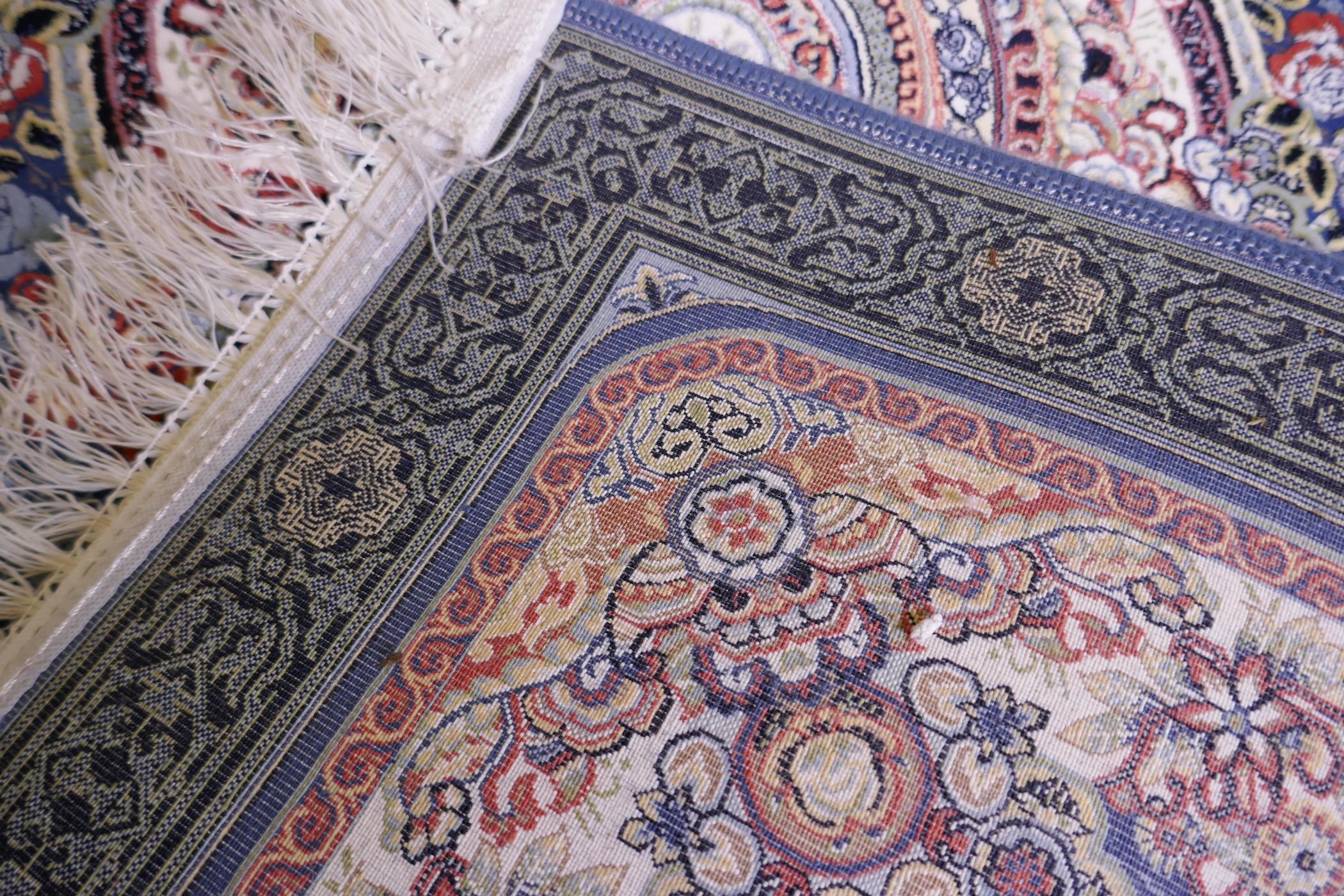 An Iranian fine woven blue ground runner with a medallion design surrounded by an embossed all - Image 5 of 5