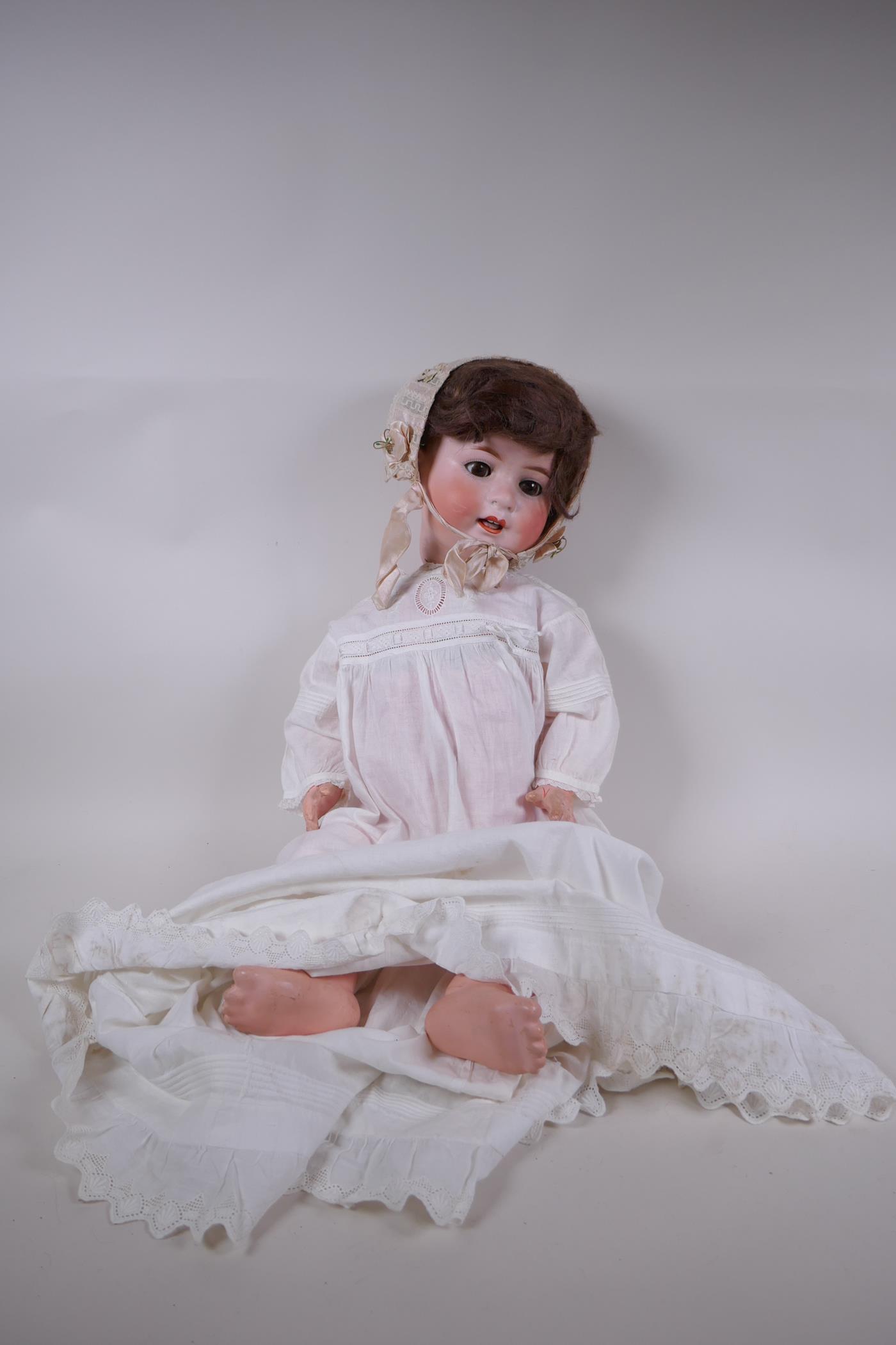 An antique German Heubach Koppelsdorf bisque headed toddler doll with brown sleeping eyes, moving