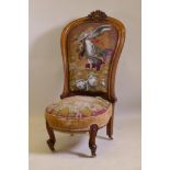 A Victorian walnut nursing chair with carved crest and shaped back, beadwork upholstery, raised on