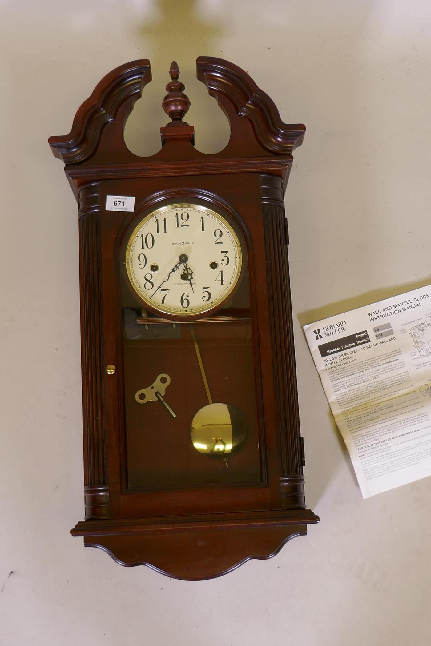 A Howard Miller mahogany cased wall clock, with spring driven movement and Westminster chimes,