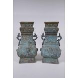 A pair of Chinese archaic style bronze vases with two dragon loop handles, lack bases, 32 cm high