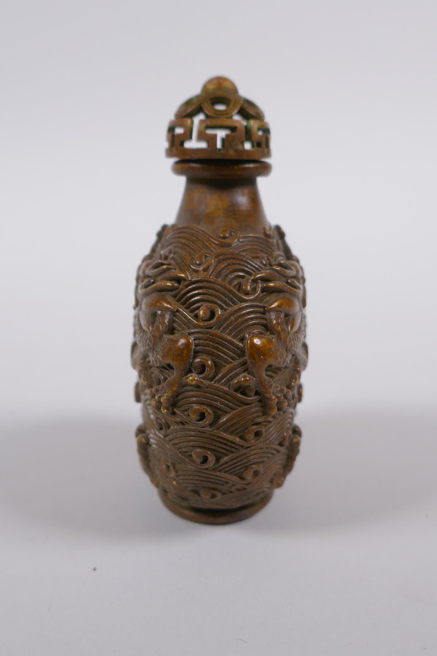 A Chinese bronze snuff bottle with raised dragon decoration, impressed 4 character mark to base, 8cm - Image 2 of 4