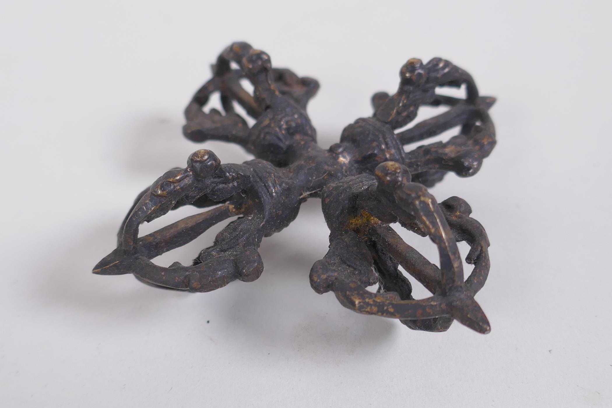 A Tibetan bronze double vajra, together with a larger vajra, 16cm long - Image 2 of 4