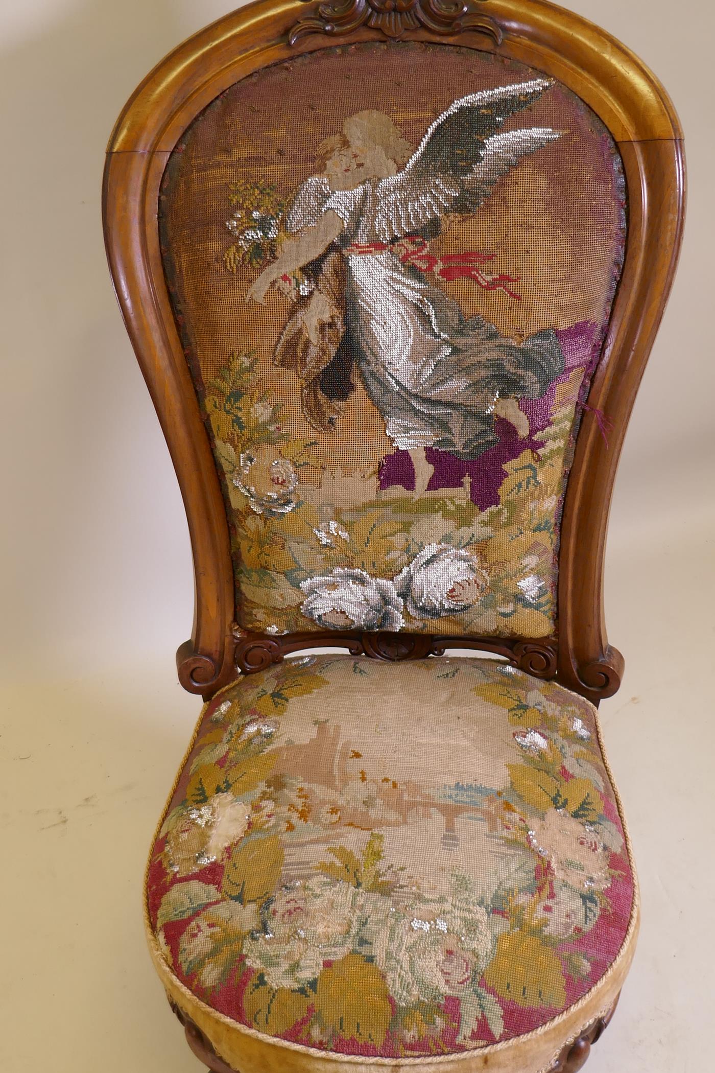 A Victorian walnut nursing chair with carved crest and shaped back, beadwork upholstery, raised on - Image 3 of 3