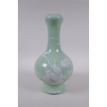 A celadon glazed porcelain garlic head shaped vase with raised white enamel decoration of birds