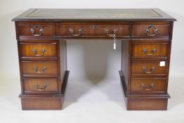 A Victorian style mahogany eight drawer pedestal desk, with leather inset top, raised on a plinth,